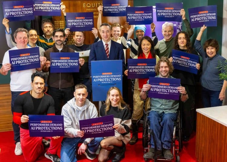Equity general secretary Paul W Fleming surrounded by Equity members holding placards that say Performers Demand AI Protections In Film And TV