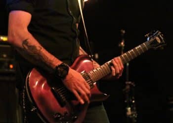 Close up of a person playing electric guitar