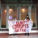 Supporters of the hunger strikers outside the Ministry of Justice hold a banner saying Elbit Corrupts Justice