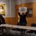 Protestor holds sign saying QMUL: End Cruel Sepsis Experiments