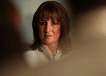 Rachel Reeves looks into the distance looking confident with a shadowy, blurred effect around the edges of the photo