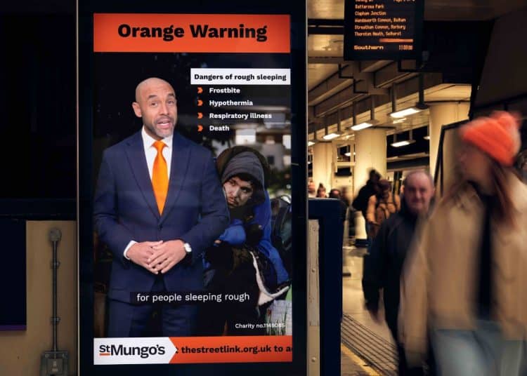 A rough sleeping weather alert on an electronic billboard in a railway station