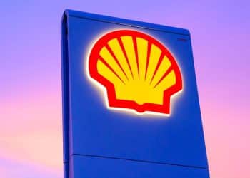 Shell logo on a sign against a sunset