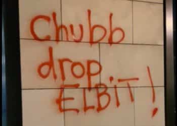 Graffiti reading Chubb Drop Elbit! on wall of insurers office in Vienna