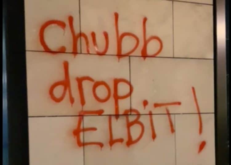 Graffiti reading Chubb Drop Elbit! on wall of insurers office in Vienna