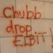Graffiti reading Chubb Drop Elbit! on wall of insurers office in Vienna