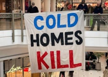 Banner reading Cold Homes Kill as MPs criticise insulation scheme