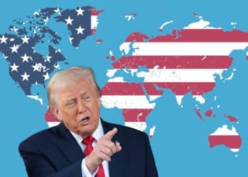 Donald Trump pointing at a world map where all the countries are coloured with the US flag