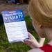 A person reads a flyer for Equity - PACT negotiations including AI protections