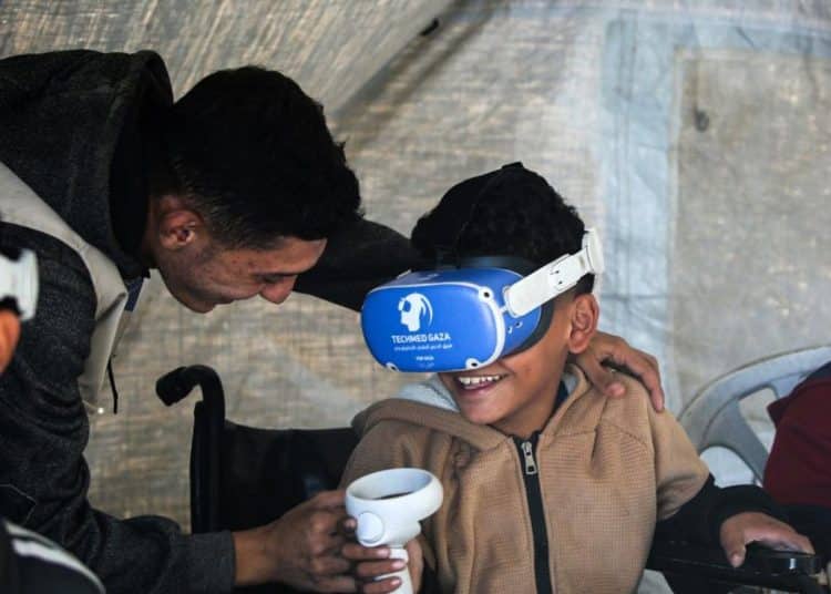 A therapist helps a child use a VR headset for trauma therapy, Gaza