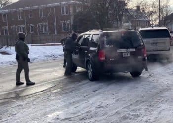 ICE agents surround a vehicle