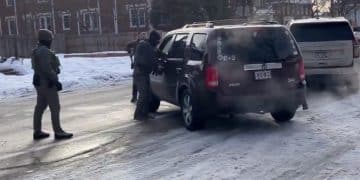 ICE agents surround a vehicle
