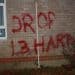 Red graffiti saying Drop L3Harris on the wall of Smiths Metal, believed to have links to the arms manufacturer L3Harris