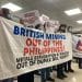 Activists hold a banner saying British Mining Out Of The Philippines!