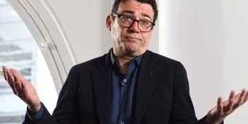 Andy Burnham with his hands up in the air mid-shrug