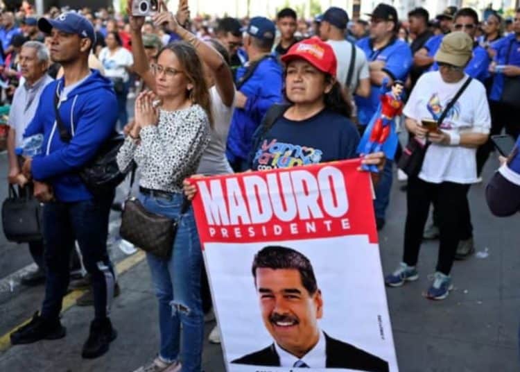 Protester holds a placard with a picture of Venezuelan president Maduro