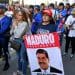 Protester holds a placard with a picture of Venezuelan president Maduro