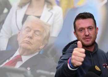 Tommy Robinson in front of an image of Donald Trump sleeping