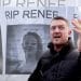 Tommy Robinson in front of an image of Renee Good