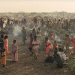 Adults and children stand and sit in the remote desert landscape of Sudan