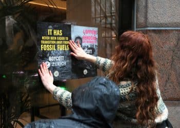 Campaigners flyposting at an office of Zurich Insurance Group