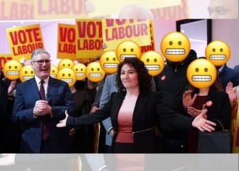 Keir Starmer and Angeliki Stogia with people standing behind them with the grimacing face, Labour