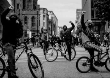Young people on bicycles in street, illustrating Manchester Resist Britain First action