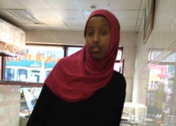 Zahwa Salah Mukhtar dressed in a red hijab and black dress