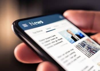 A phone showing an online News feed Press regulation