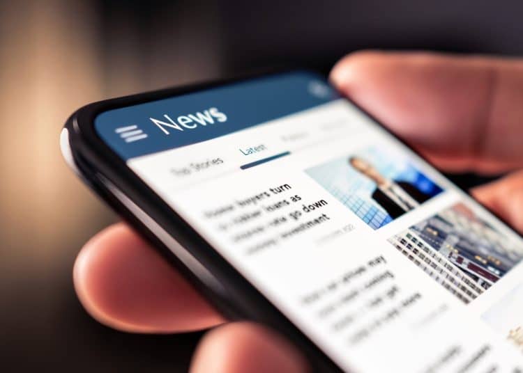 A phone showing an online News feed Press regulation