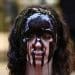 Activist covered in treacle in protest against oil company Equinor