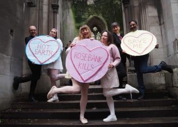 Protesters against Rosebank oil field hold giant love hearts saying Hot Earth, Rosebank Kills, Save Me