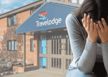 Travelodge hotel in the background with a woman crying with her head in her hands in the right foreground