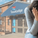 Travelodge hotel in the background with a woman crying with her head in her hands in the right foreground