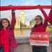 Fossil Free London protesters across the Thames from parliament hold a red ribbon and a sign saying Hold The Line #StopRosebank Rosebank