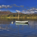 Scenic landscape photo of a boat in the middle of Lake Windermere, Cumbria
