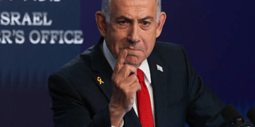 Benjamin Netanyahu, Israel prime minister, pointing his index finger from a podium, looking smart as if delivering a speech