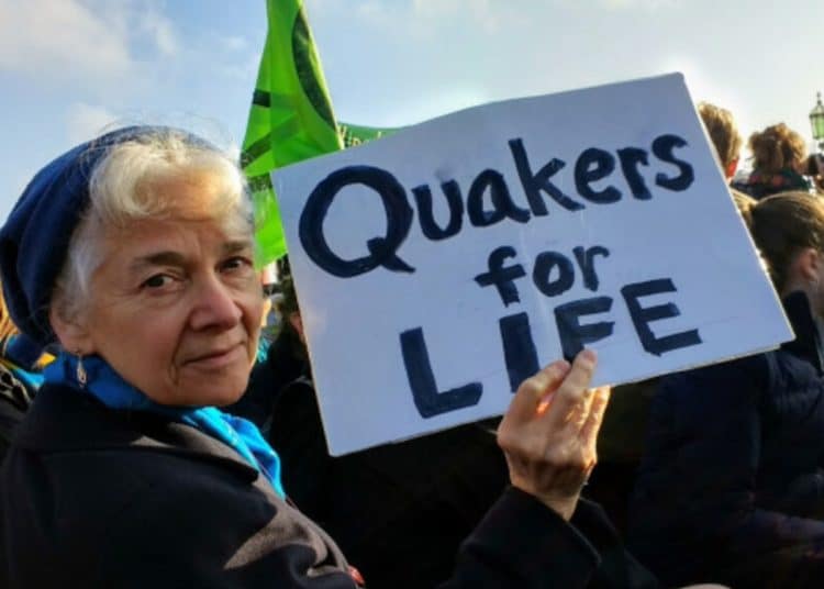 Woman holds a sign saying Quakers For Life