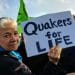 Woman holds a sign saying Quakers For Life
