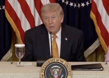 US president Donald Trump speaking at a microphone