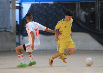 Gaza - Two young footballers from opposing teams chase the ball