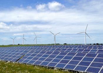 Solar farm in front of wind turbines Renewable energy