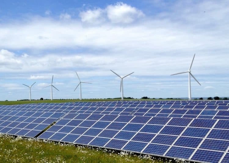 Solar farm in front of wind turbines Renewable energy