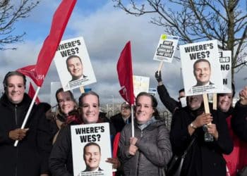 Protesters wearing Wes Streeting masks hold signs saying Where's Wes?