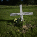 DWP cutting benefits of women who received compensation after surviving mother and baby homes - image shows an unmarked infant grave with a cross that reads 'unknown infant'