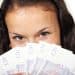 Young woman holding £20 notes Youth minimum wage