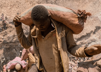 An artisanal miner carries a sack of ore at the Shabara artisanal mine near Kolwezi, DRC, on Oct. 12, 2022.