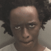 Axel Rudakubana's mug shot in which he looks unkempt and wild, and has his mouth tightly shut. He killed the three girls in Southport where they were attending a dance class.
