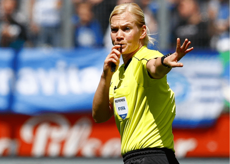 Female referree, Bibiana Steinhaus, blows her whistle and motions for the game to pause at the league match between MSV Duisburg and FSV Zwickau in Duisburg in May 2017