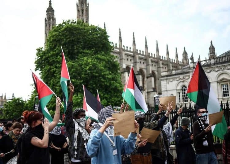 Palestine flags wave in front of King's College Chapel Cambridge. ICJP letter to universities over surveillance.